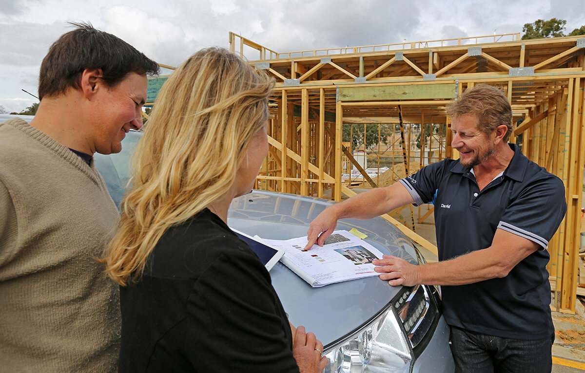 A picture of David helping two clients with their new home building inspection.